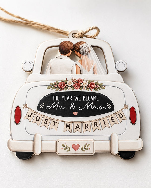 Wooden wedding ornament showing a bride and groom in a classic car with flowers and a Just Married banner