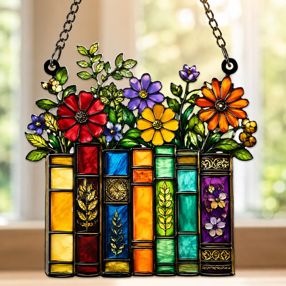 Acrylic book suncatcher featuring colorful books topped with flowers and leaves.