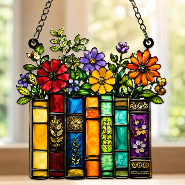 Acrylic book suncatcher featuring colorful books topped with flowers and leaves.